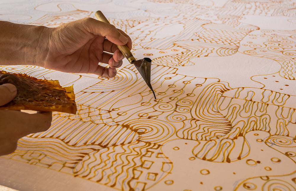 Painting with candles for a batik work